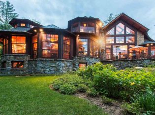 Lake Placid home exterior with iron railing on deck. 