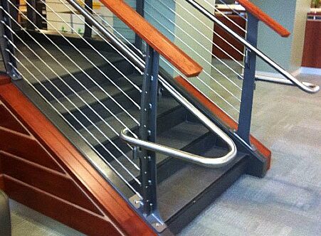 ADA handrails made of stainless steel on curved cable railing with cherry top rail.