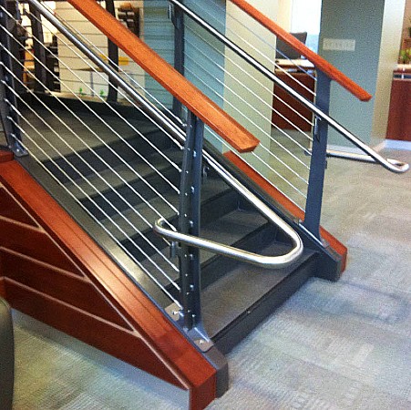 ADA handrails made of stainless steel on curved cable railing with cherry top rail.