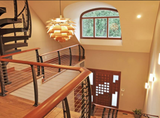 Grand entry with modern spiral staircase and balcony cable railing