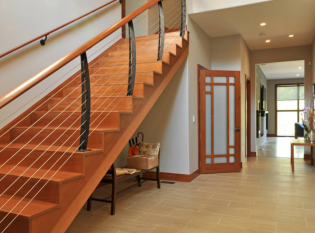 Curved staircase cable railing on in modern home entrance