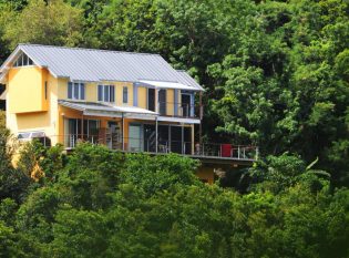 Caribbean home with custom cable railing decks