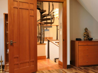 Modern spiral stairs as seen through doorway