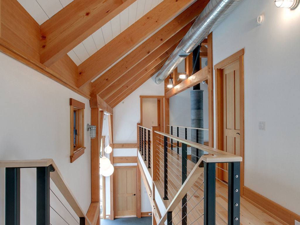 Cable railing in the Ithaca style on stairs and catwalk in this post and beam home.