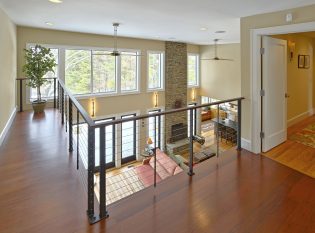 Balcony with window view of landscape through cable railing