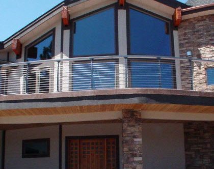 Second story concrete curved deck cable railing.