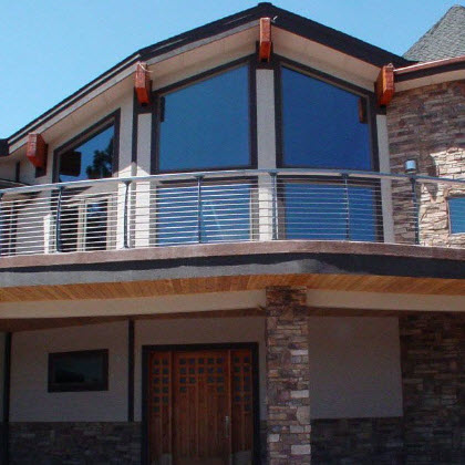 Second story concrete curved deck cable railing.