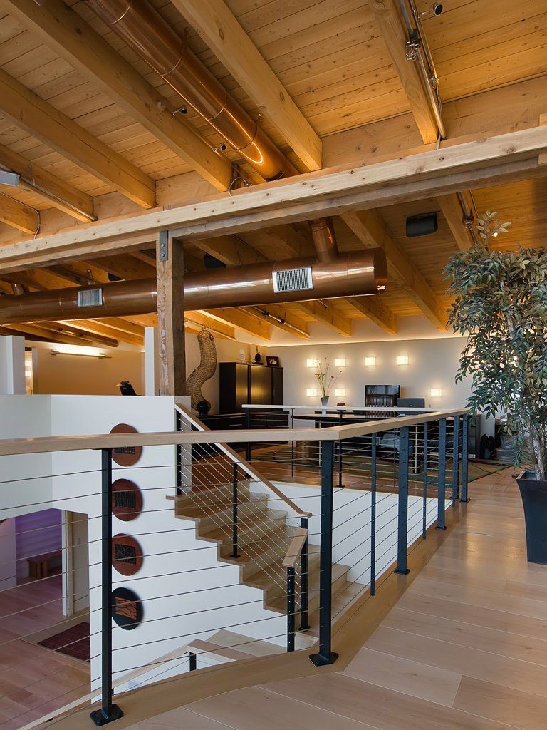 Second story loft and staircase with Ithaca style cable railing