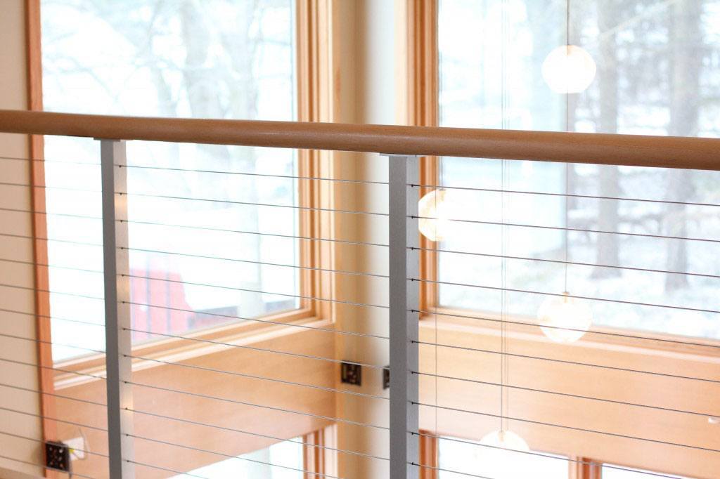 Ithaca style railing on a loft keeps the view open to the windows.