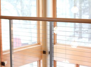 Cable railing allows for an open view out the expansive windows