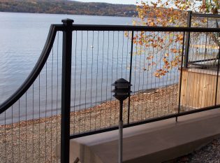 Cables run vertically on stone retaining wall