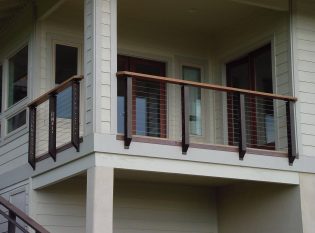 Covered deck cable railing with prairie styling