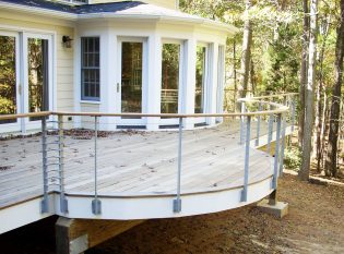 Curved ipe deck with custom posts and 316 stainless cables and fittings