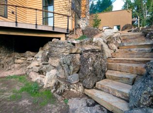 Curved stone landscape leading to curved outdoor deck