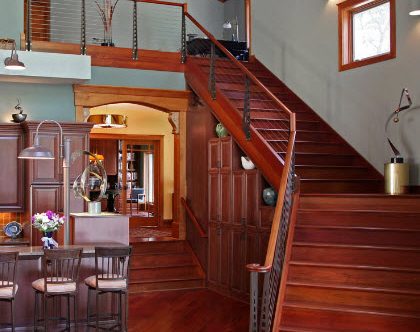 Cherry staircase cable railing in the Chicago Style with custom designed newel post -Delwan Wi