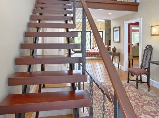 Double stringer floating staircase with cable railing and wood treads