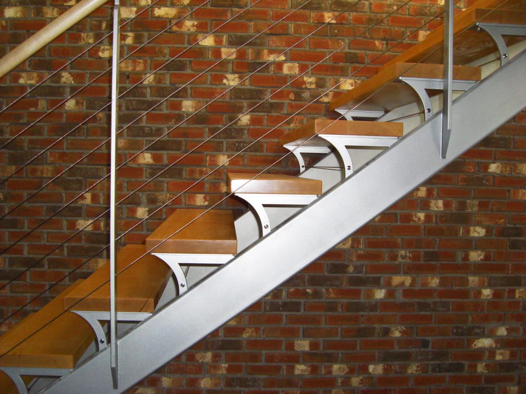 Dual steel stringer stair with custom tread supports.