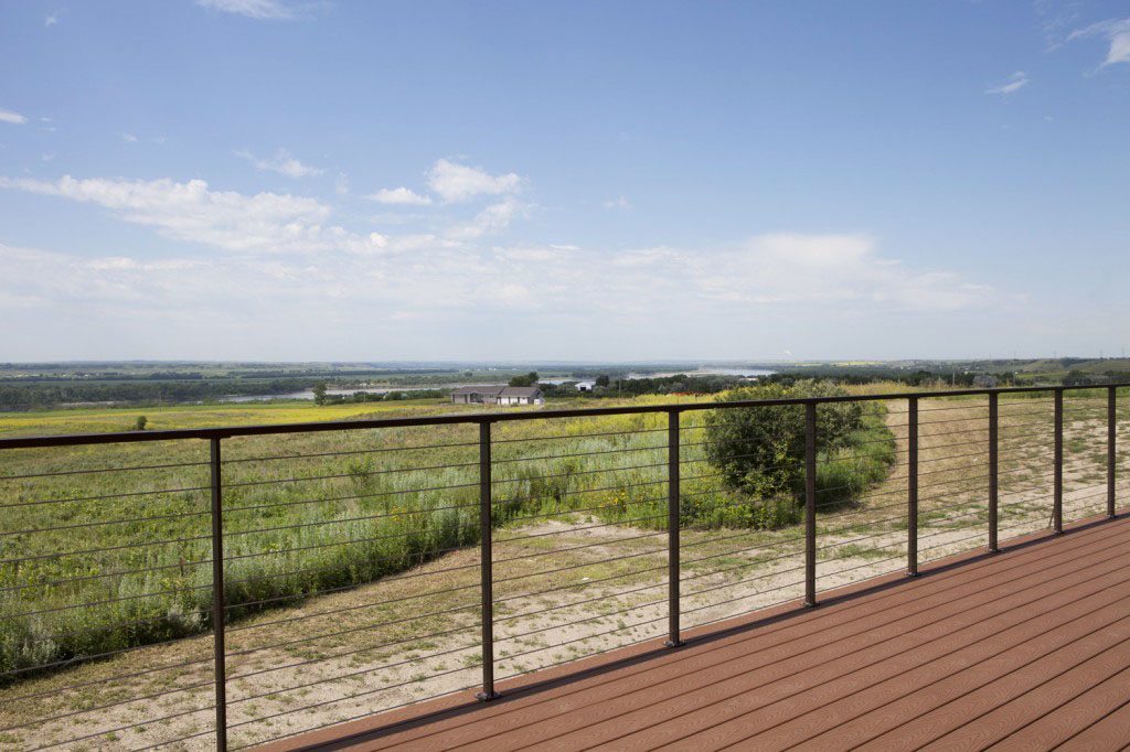 Expansive view of the river beyond can be seen from this observation deck with cable railing post color oil rubbed bronze.