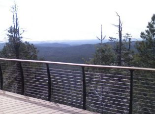 Cable railing on log cabin deck