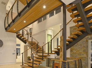 Floating staircase with cable railings by keuka studios