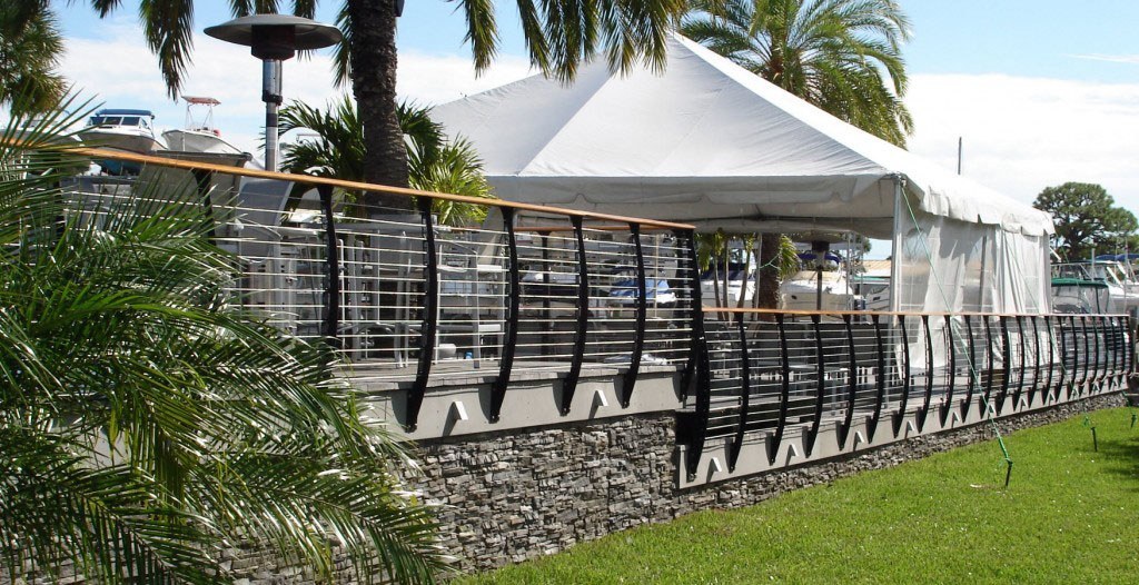 Marina deck curved railing with party tent.