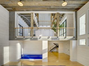 Indoor basketball court and reclaimed wood ceilings with keuka cable railing overlook