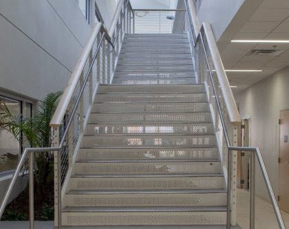 cable railing and ADA compliant graspable handrail on interior staircase at the Jacksonville University.