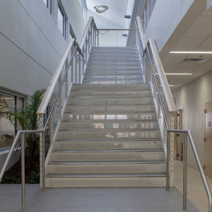 cable railing and ADA compliant graspable handrail on interior staircase at the Jacksonville University.