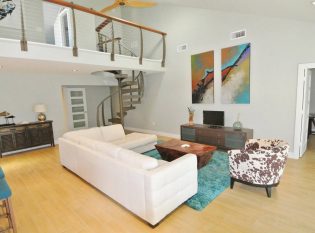 Spiral staircase with balcony overlooking the living room