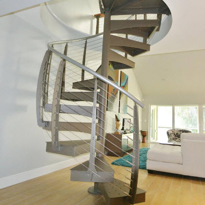 Custom made spiral staircase leading to upper level balcony