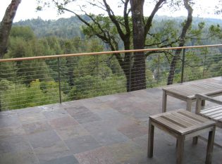 Keuka Studios Ithaca style railing complements the slate deck and rolling hillside