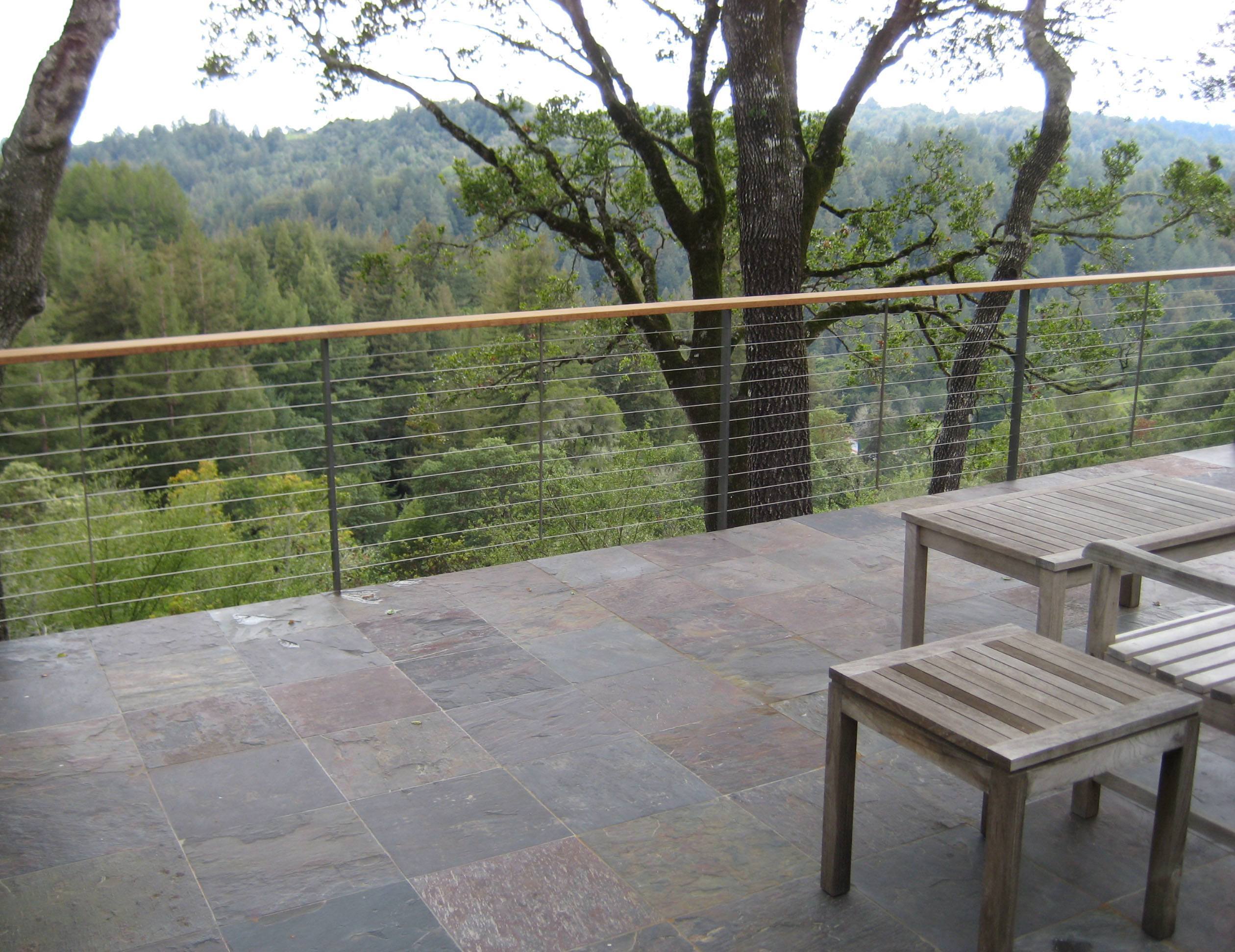 Keuka Studios Ithaca style railing complements the slate deck and rolling hillside