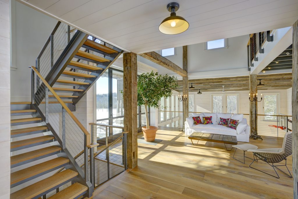 Ithaca style cable railing  posts and industrial style stair stringers  in open activity barn.