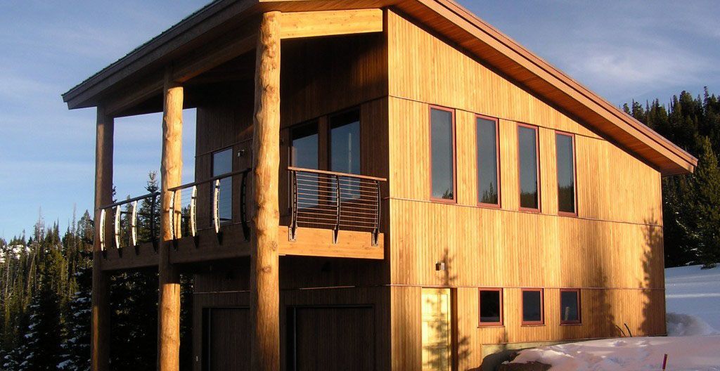 Heavy log timbers with bronze railing posts and cables.