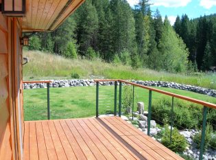 Mountain vista with rock landscaping seen through cable railing