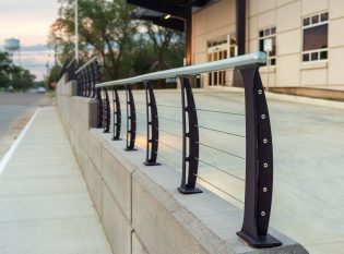 Railing mounted on retaining wall