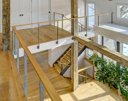 Indoor cable railings and stairs were made for this party barn with half basketball court