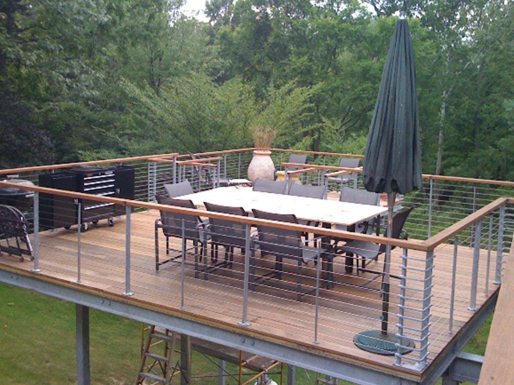 Simple aand Clean Lines Cable Railing For This Uniqued Deck Dining Area