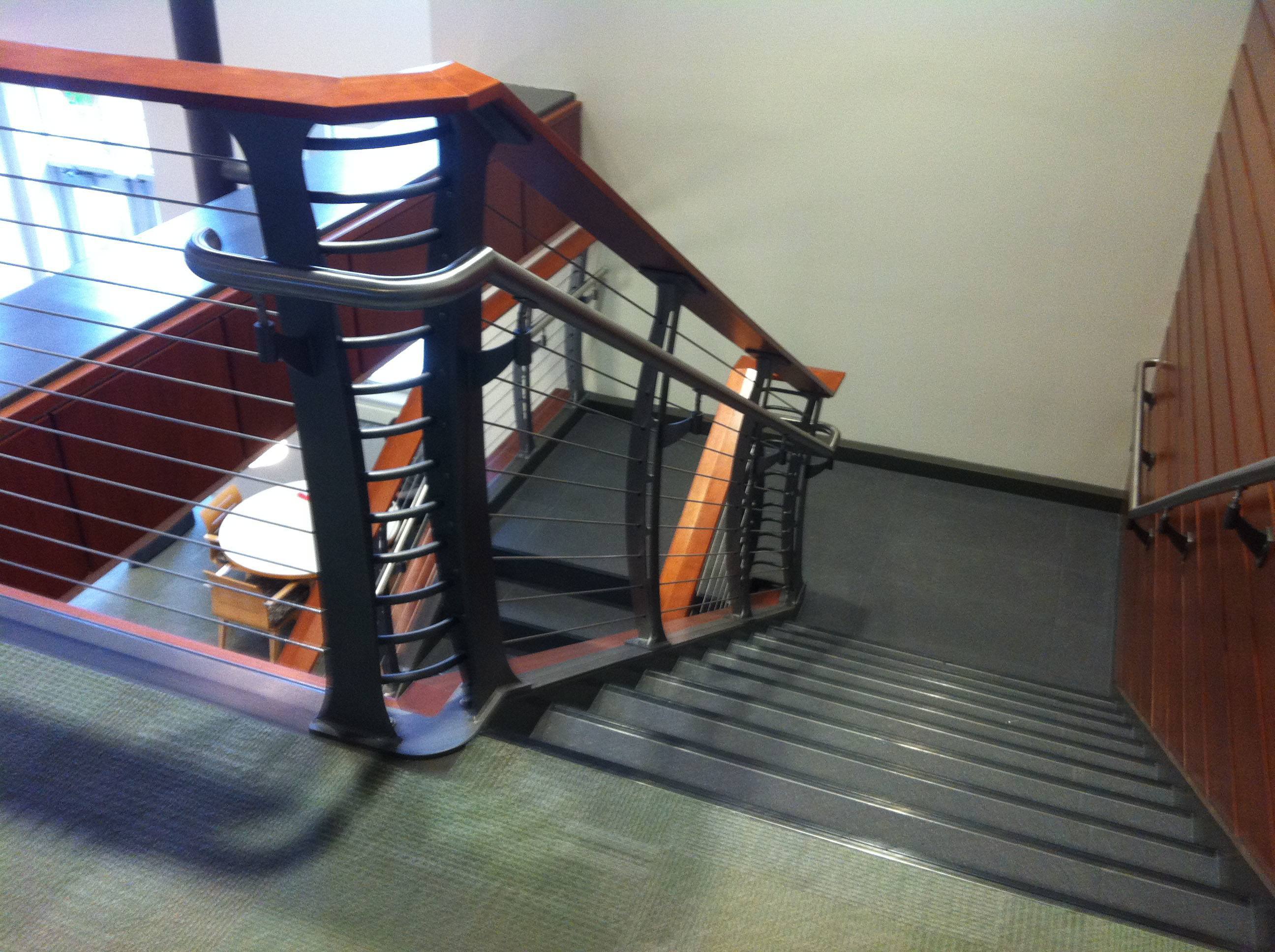 Stainless steel handrail on both sides of the staircase designed to meet the albany college requirements 