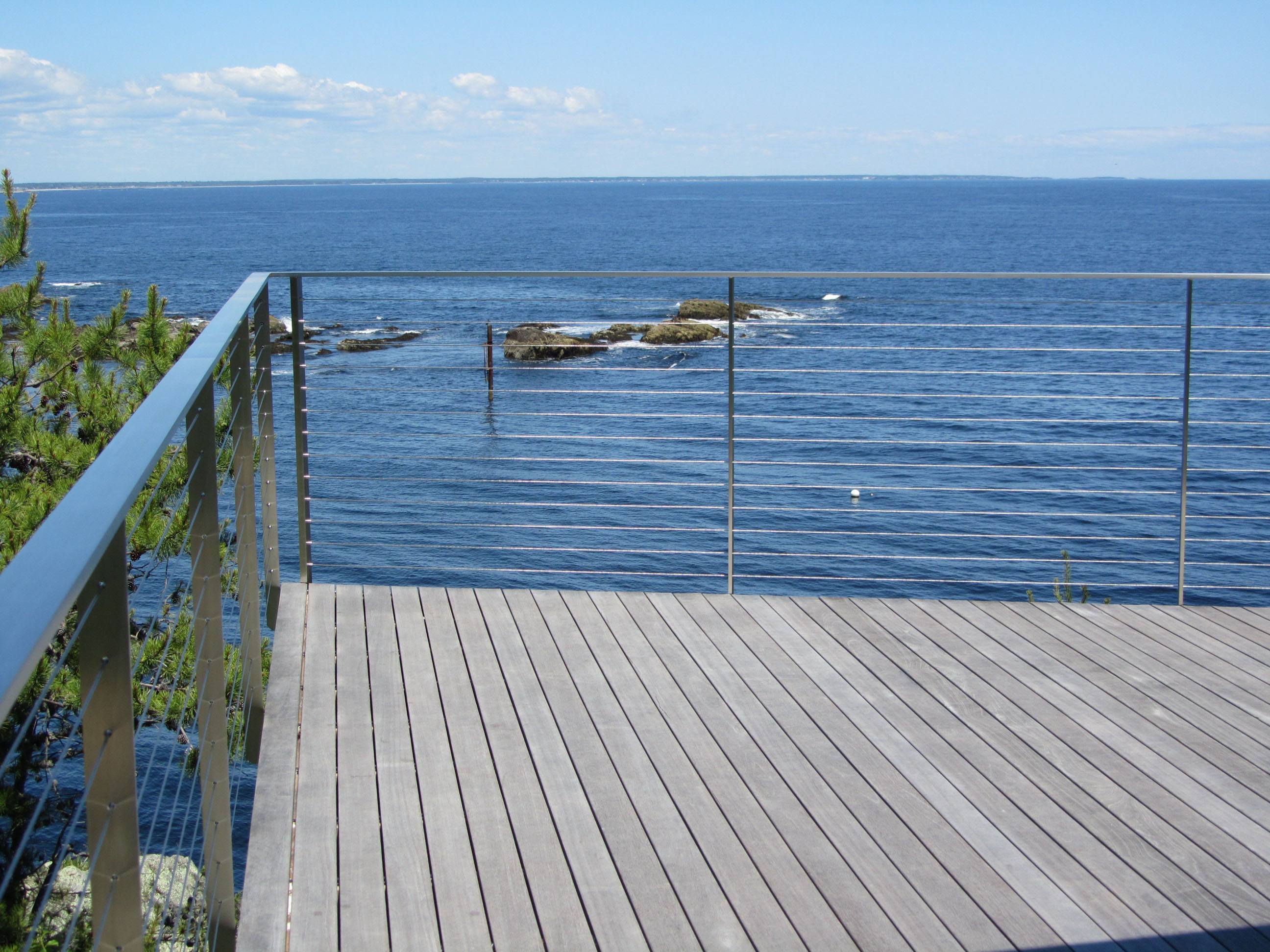 Stainless wire rope railing practically vanishes preserving the ocean view