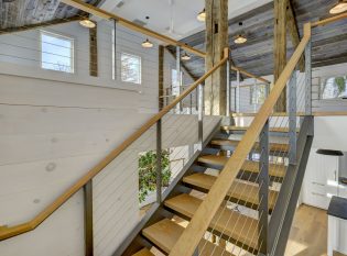 Steel channel staircase with cable rail leading to the loft