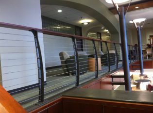 The library loft at albany college over looking the main lobby with curved cable rail system