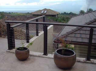 Top mounted cable railing on concrete wall 