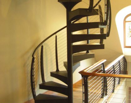 Modern Spiral Staircase with curved cable railing leading to upper level library loft - Watchung NJ