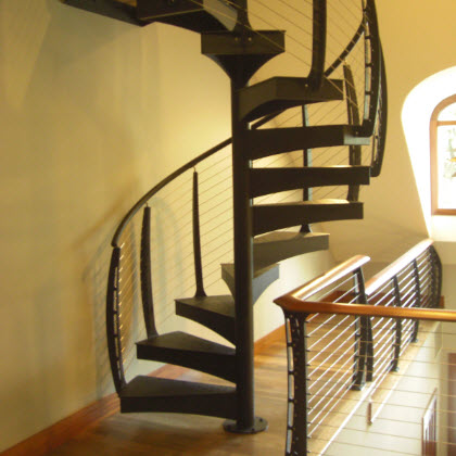 Modern Spiral Staircase with curved cable railing leading to upper level library loft - Watchung NJ