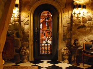 Wine cellar door with hand forged grapes and vines