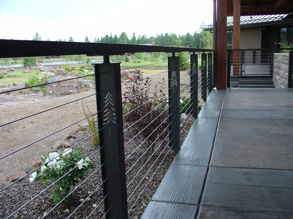 Prairie cable railing post with pine tree motif.