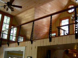 Knotty pine loft with industrial styling and cable railing system