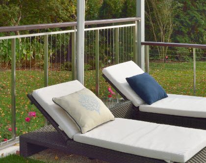 Stainless steel cable railing with wood top rail.