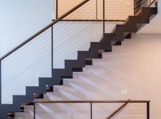 Floating staircase with zig zag stair stringers